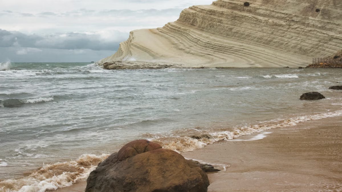 Breathtaking view of Scala dei Turchi's iconic white cliff and beach in Sicily, Italy.